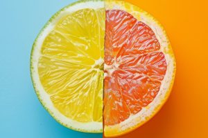 A picture of a half of a lemon with a half of a grapefruit