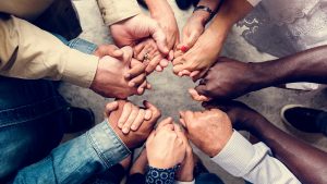 Circle of diverse clasped hands