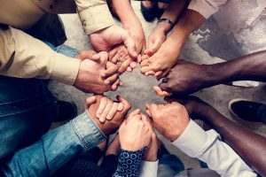 Circle of diverse clasped hands