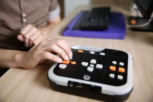 Hand using an assistive technology device