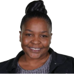 Middle aged black woman with black hair in a bun wearing a gray blouse and black collared shirt