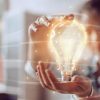 Asian student holding a technology enhanced lightbulb; artistic rendering