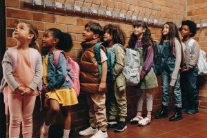 A group of school-age children standing in line