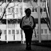 Black and white image of a child wearing a backpack.