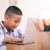 A child working on a laptop.