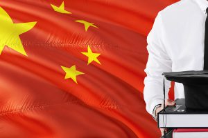A person standing in front of the Chinese flag.