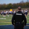 A police officer standing on a sports field.