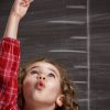 A child reaching up toward the ceiling.