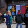 A person waving outside of the Baltimore Montessori Public Charter School.