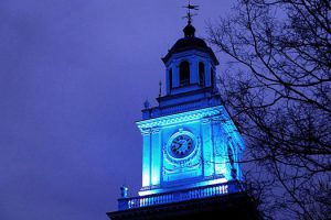 A clock tower at night on the Johns Hopkins University Homewood campus.