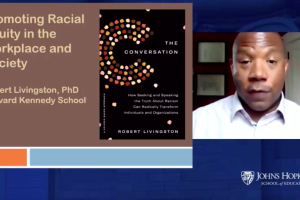 A screenshot of a video conference call with a graphic that says, "Promoting Racial Equity in the Workplace and Society" and an image of Robert Livingston.
