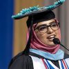 Leila Khalid Warraich speaking at a microphone.