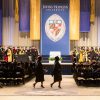 Graduates walking at a Johns Hopkins University graduation ceremony.