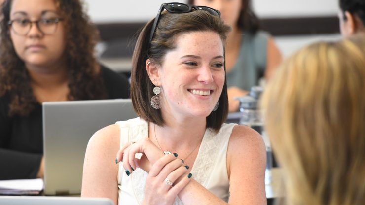 A person in a classroom smiling.