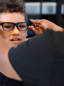 A young child wearing glasses.