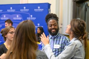 A group of Johns Hopkins School of Education students standing and smiling.