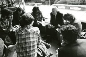 A group of people sitting in a circle and talking.
