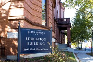 The Johns Hopkins University School of Education brick building with the building's sign displayed