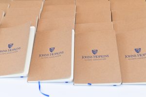 Notebooks that say Johns Hopkins Alumni Association.