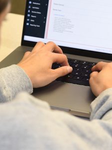 A person typing on a laptop.