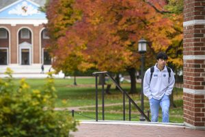 A student walking on the Johns Hopkins University Homewood campus.
