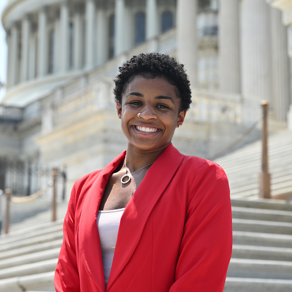 A person standing in front of the United States Capitol.