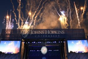 The Graduation Stage with fireworks going off in celebration behind it