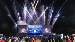 fireworks ignight behing the graduation stage at the 2025 Johns Hopkins School of Education Graduation