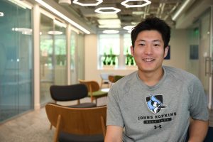 A person sitting in a chair smiling for a camera.