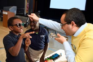 Two children getting fitted for their eyeglasses prescription.