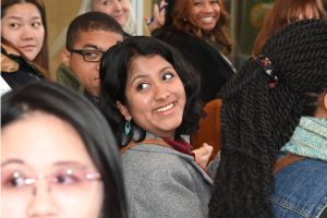 A group of students, alumni, faculty and Staff listen to questions
