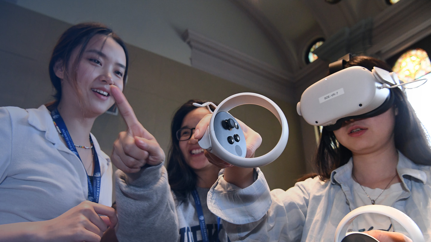 Three people using a virtual reality headset.