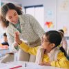 A teacher and a student high fiving.