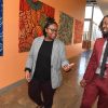 Two people walking in a hallway of a school engaging in conversation