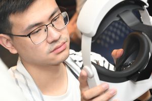 A person putting on a virtual reality headset