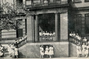 Several students in a historic picture outside the current School of Education building