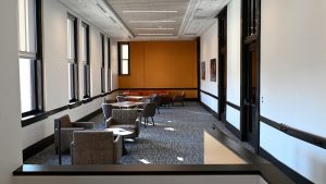 A lounge area with tables and chairs