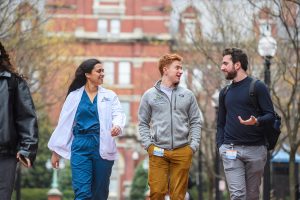 Three people walking and talking outside