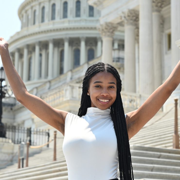 A person standing in front of the United States Capitol