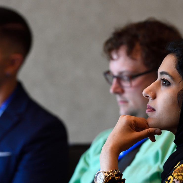 Three people sitting in a class lecture