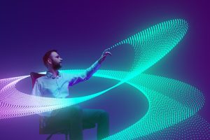 A person sitting in a desk chair with a graphic coming out of their hand