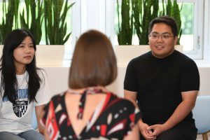 Three people sitting down having a conversation